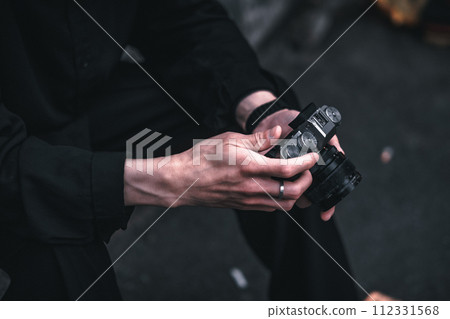 Man's hand touching the camera 112331568