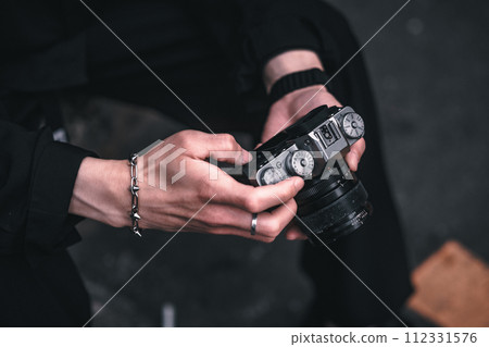 Man's hand touching the camera 112331576