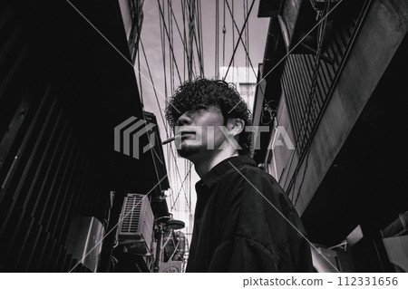 man standing in back alley man standing in back alley 112331656