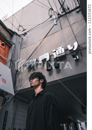 man standing in back alley man standing in back alley 112331672