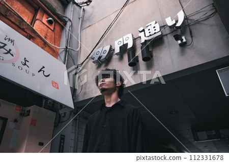 man standing in back alley man standing in back alley 112331678