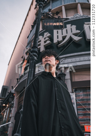 A man waiting in front of a retro building 112331710