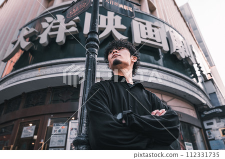 A man waiting in front of a retro building 112331735