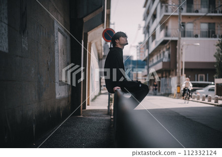 man standing in the alley 112332124