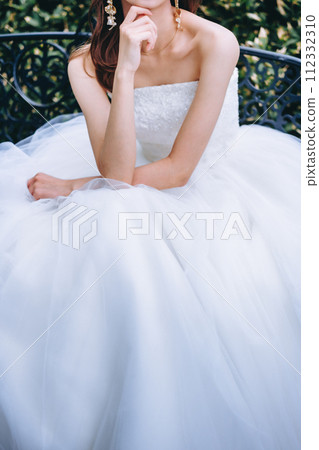 bride sitting on a bench 112332310