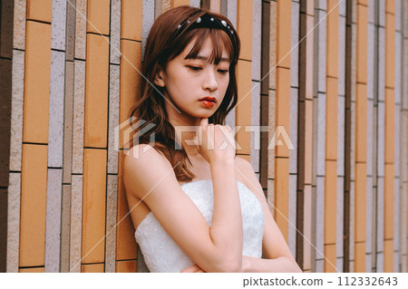 Bride in wedding dress posing in front of colorful wall 112332643