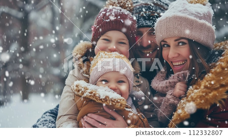 Happy family smiling and having fun in front of the camera during winter snowfall. Happy family smiling and having fun in front of the camera during winter snowfall. 112332807