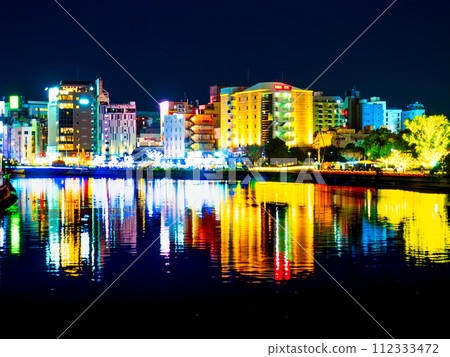 A night view of Nakasu, the busiest district in western Japan, and its surroundings, taken from the Nada River Bridge that spans the Naka River in Fukuoka City, Fukuoka Prefecture. A night view of Nakasu, the busiest district in western Japan, and its surroundings, taken from the Nada River Bridge that spans the Naka River in Fukuoka City, Fukuoka Prefecture. 112333472