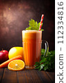 A refreshing orange and carrot smoothie in a tall mug, garnished with parsley on a wooden surface. 112334816