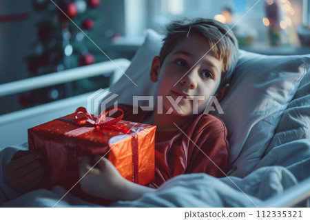 Boy in hospital room with gift box 112335321