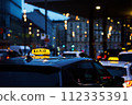 Twilight Taxi Service in City Center During Rush Hour Traffic 112335391