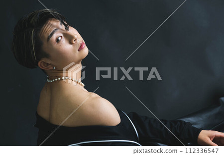 A young and handsome man with amazing muscles on a black background A young and handsome man with amazing muscles on a black background 112336547