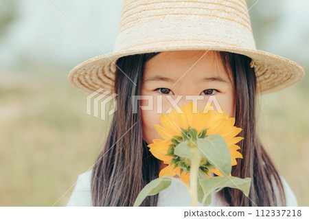 A girl with a sunflower A girl with a sunflower 112337218