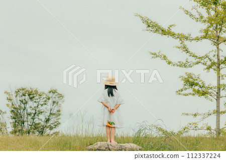 A girl with a sunflower A girl with a sunflower 112337224