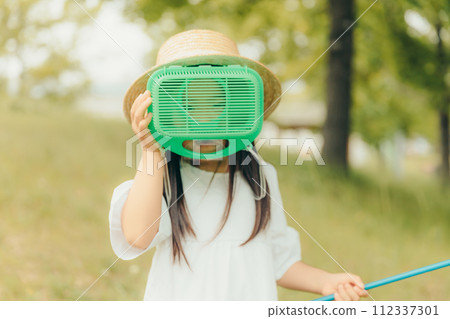 Girl running around with a butterfly net 112337301
