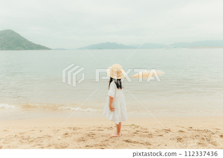 Girl with dried flowers on the beach Girl with dried flowers on the beach 112337436