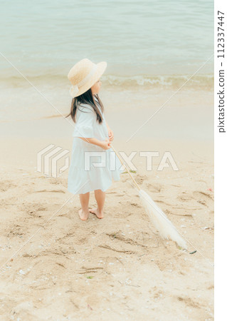 Girl with dried flowers on the beach Girl with dried flowers on the beach 112337447