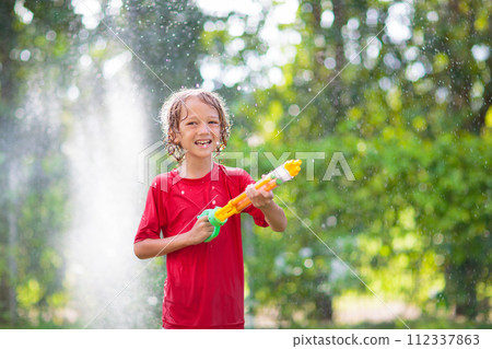 Kids play with water sprinkle hose. Summer garden Kids play with water sprinkle hose. Summer garden 112337863