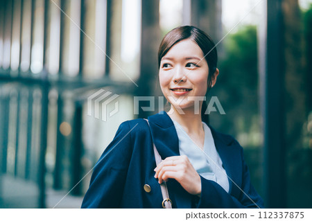Businesswoman with office building in the background Businesswoman with office building in the background 112337875