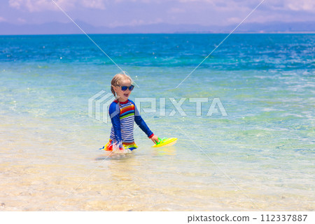 Kids playing on beach. Children play at sea. Kids playing on beach. Children play at sea. 112337887