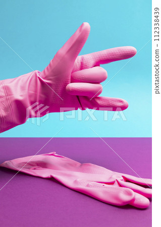 Hand in Pink latex glove showing devil, heavy metal or rock and roll sign Hand in Pink latex glove showing devil, heavy metal or rock and roll sign 112338439