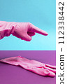 Hand in Pink latex glove pointing index finger 112338442