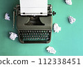 Vintage typewriter and crumpled paper sheets. Writer and blogger concept. Top view, flat lay 112338451