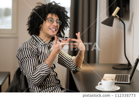 Young man in striped shirt recording a voice message Young man in striped shirt recording a voice message 112338773