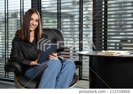 Smiling young business woman working in the office 112338868
