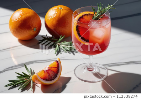 Summer refreshing soda drink or alcoholic cocktail with ice, rosemary and blood orange on a white marble table. 112339274