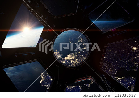 The night Earth from porthole on space station. 112339538