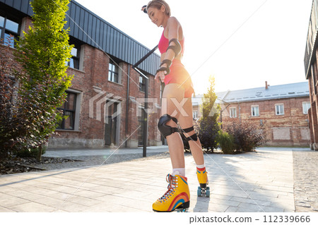 Woman skating in the street on a nice sunny day 112339666
