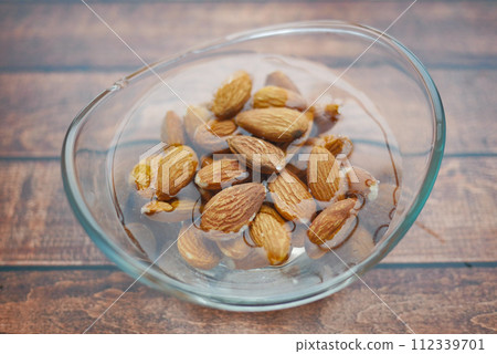 Close up of almond nuts in a bowl of water  112339701