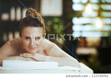relaxed 40 years old woman in spa salon laying on massage table 112339762