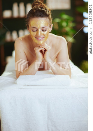 relaxed modern woman in massage cabinet laying on massage table 112339801