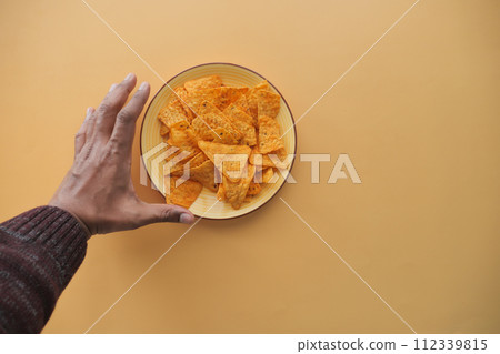 top view of men hand pick potato chips top view of men hand pick potato chips 112339815