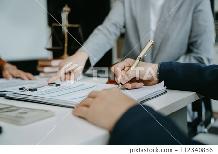 Legal counsel presents to the client a signed contract with legal law. justice and lawyer concept in office. Legal counsel presents to the client a signed contract with legal law. justice and lawyer concept in office. 112340836
