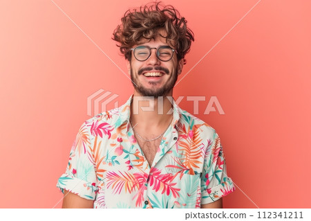 A man with glasses and a floral shirt is smiling 112341211