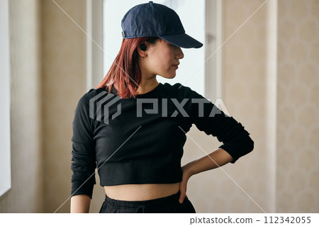 Young woman practicing dancing while listening to music 112342055