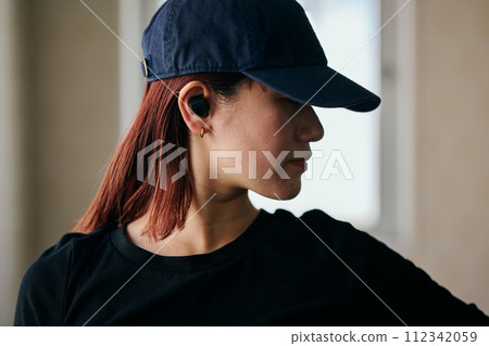 Young woman practicing dancing while listening to music Young woman practicing dancing while listening to music 112342059