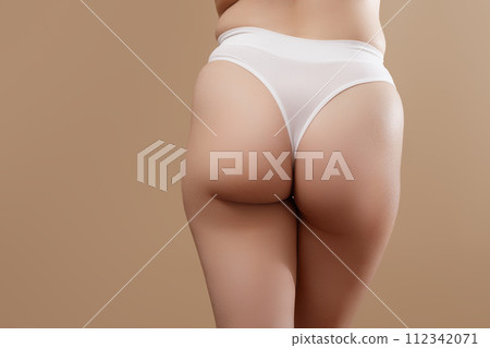 Cropped image of female buttocks in underwear Cropped image of female buttocks in underwear 112342071