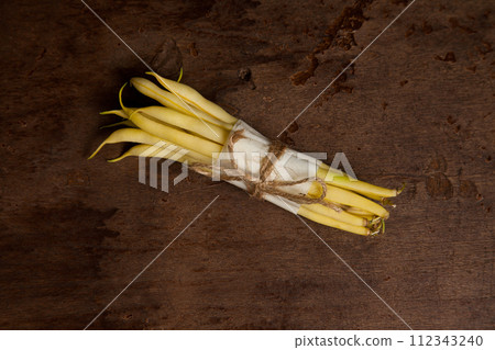 Bunch of flat runner bean pods heap on wooden background. . 112343240