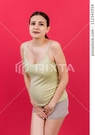 urinary incontinence during pregnancy. Abdominal pain during pregnancy. Maternity healthcare concept on colored background 112343354
