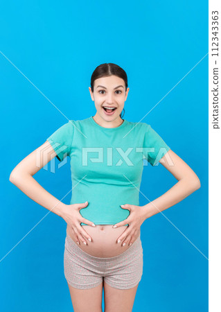 Young surprise or shocked woman pregnant isolated colored background. expression female Young surprise or shocked woman pregnant isolated colored background. expression female 112343363