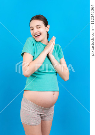 Young beautiful pregnant woman on isolated colored background celebrating surprised and amazed for success with arms raised and open eyes. Winner concept Young beautiful pregnant woman on isolated colored background celebrating surprised and amazed for success with arms raised and open eyes. Winner concept 112343364