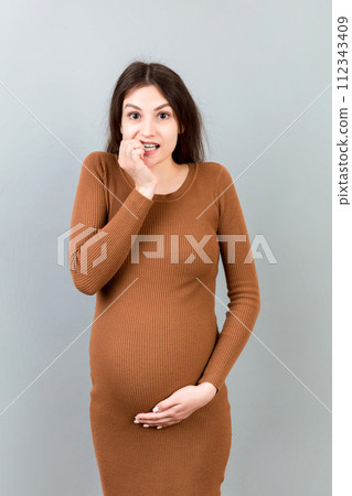 Stressed or angry pregnant woman. Pregnancy mother problems on colored background isolated Stressed or angry pregnant woman. Pregnancy mother problems on colored background isolated 112343409