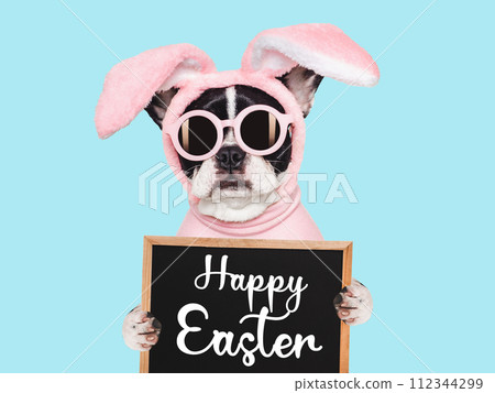 Happy Easter. Cute puppy and a basket of Easter eggs 112344299