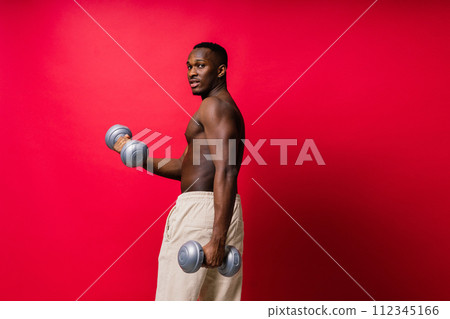 Portrait of a happy african man with dumbbells over red and black background Portrait of a happy african man with dumbbells over red and black background 112345166