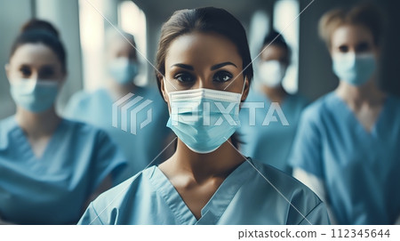 A young female doctor or nurse wearing a surgical mask looks at 112345644