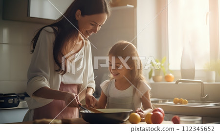 A mother and daughter are cooking together in the kitchen. They 112345652